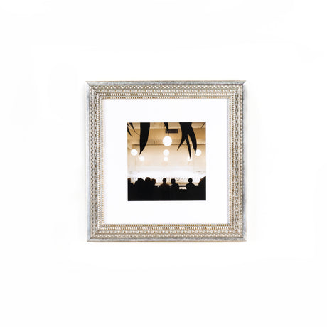 photograph on a white wall framed in brighton wide pattern silver frame