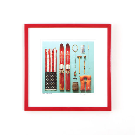 Ski and flag art in red frame on white wall